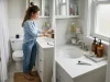 How to Organize Your Bathroom Counter That Stays Neat Organized bathroom counter with white tray, glass dispensers and corner shelf on a small vanity