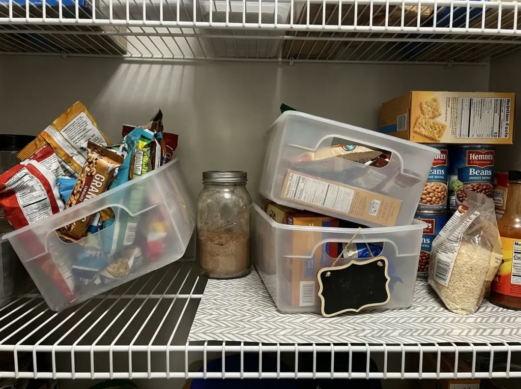 Messy pantry shelf with warped dollar store bins and unlabeled containers