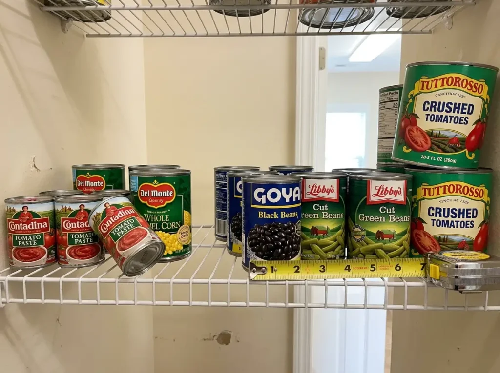 Three different can sizes on pantry shelf showing why cans don't stack together