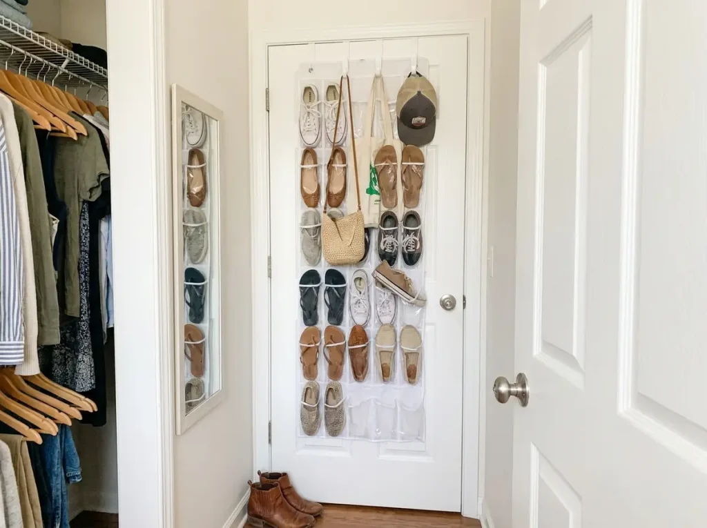 Over-door shoe organizer with clear pockets and hooks for bags inside closet