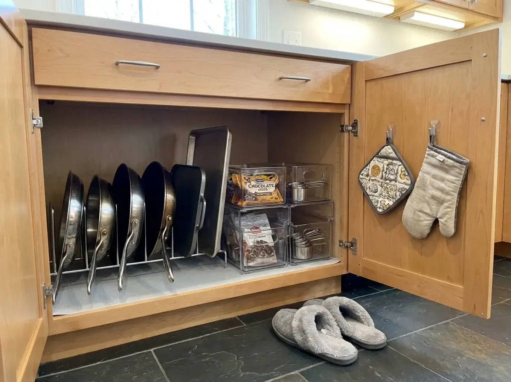 organized lower kitchen cabinet with pull-out shelf and vertical pan dividers