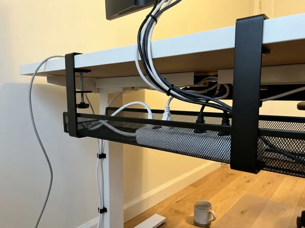 Under-desk cable management tray clamp-mounted with cables routed neatly out of sight
