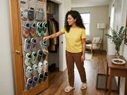 Over Door Shoe Organizer Ideas That Actually Work Italian American woman in her late 20s reaching into over-door shoe organizer on closet door in small apartment entryway