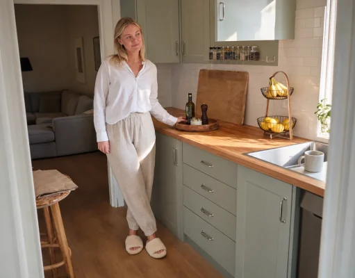 12 Kitchen Counter Organization Ideas That Stay Clear Bright kitchen with counter organized using a tray, turntable and wall shelf, one clear prep zone