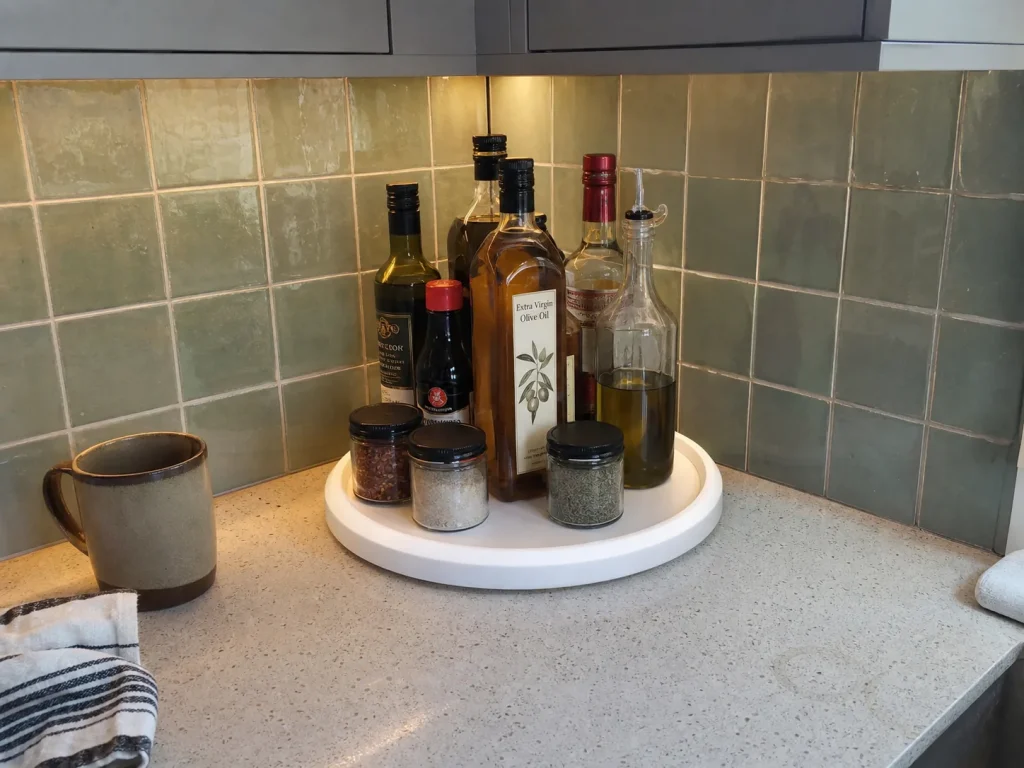 OXO lazy susan turntable in a kitchen counter corner holding oils and condiments