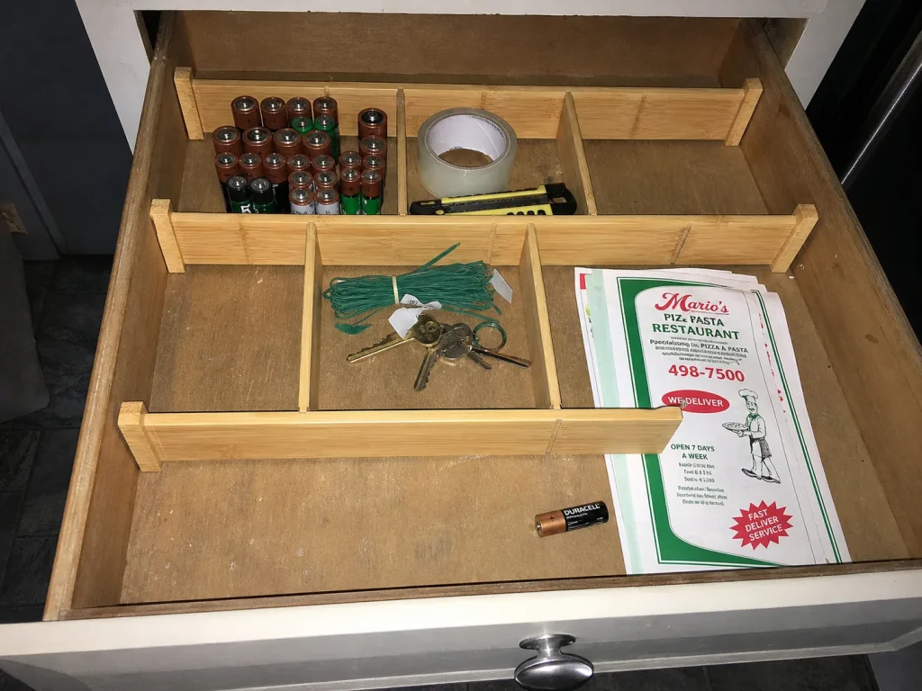 How to Declutter Kitchen Counters for Good 4 Kitchen drawer divided into labeled compartments with bamboo dividers for relocated items