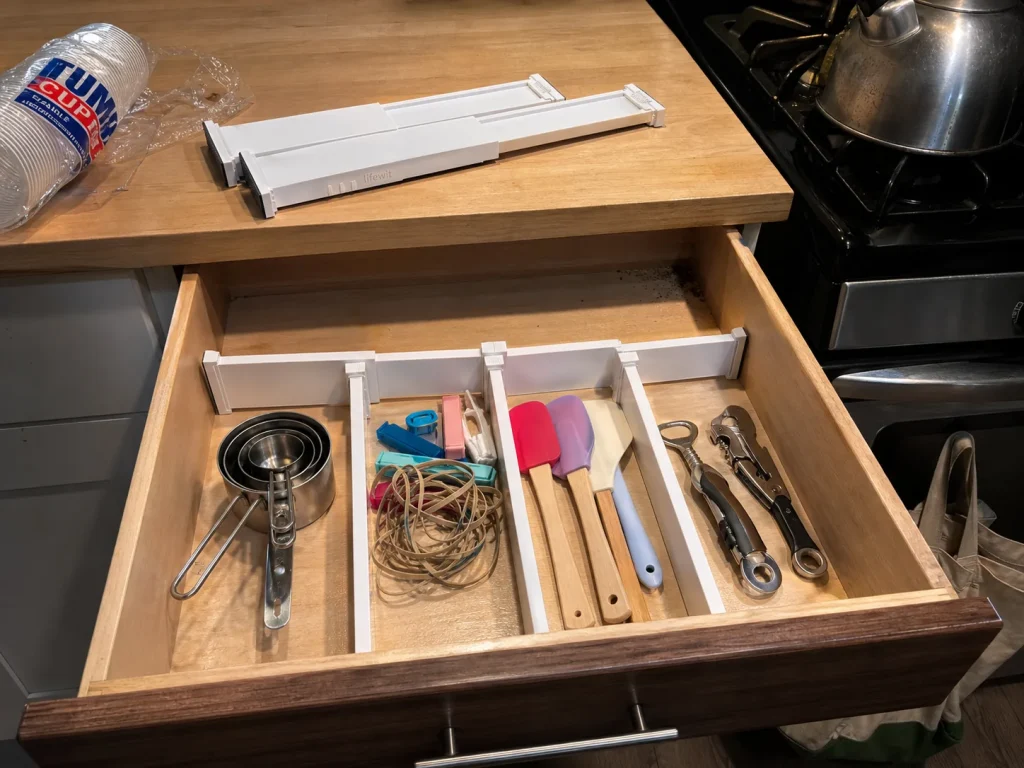 Best Kitchen Drawer Organizers That Hold Their Size 6 Lifewit adjustable drawer dividers splitting a kitchen drawer into four zones for gadgets