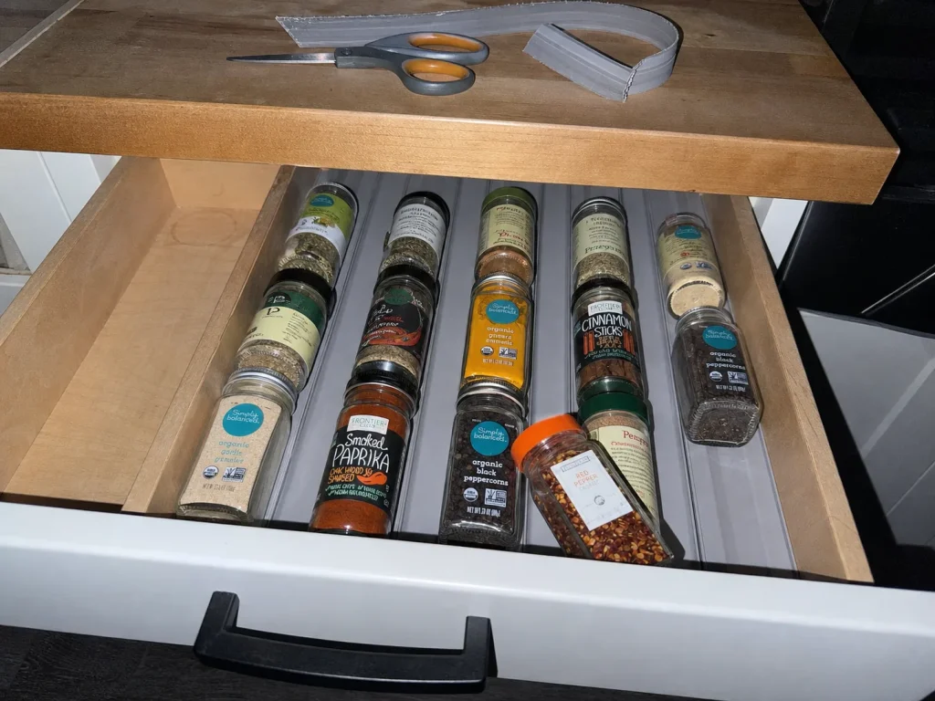 Spice Drawer Organization That Stops Jars From Rolling 5 Shallow kitchen drawer with a foam spice liner holding jars lying flat at a readable angle