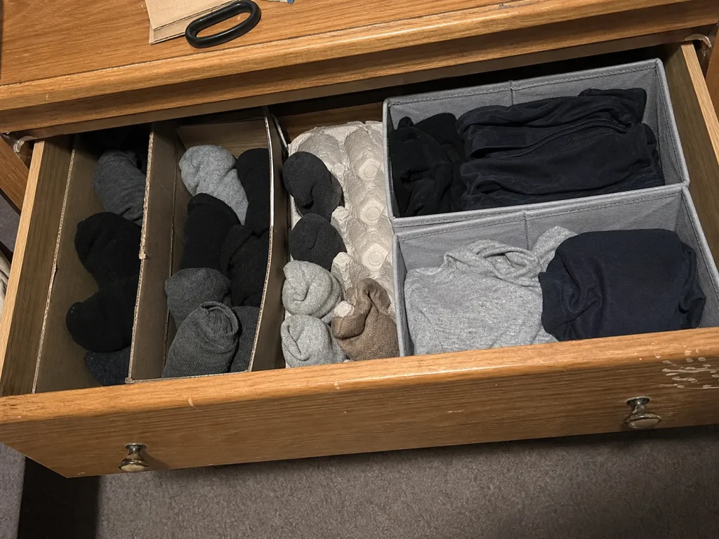 Dresser drawer using free cardboard dividers next to collapsible cloth organizer boxes