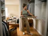Do You Need a Closet System or Just Accessories? Woman deciding between a closet system and accessories in a small reach-in closet