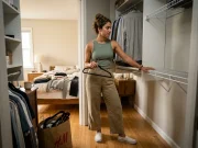 Do You Need a Closet System or Just Accessories? Woman deciding between a closet system and accessories in a small reach-in closet