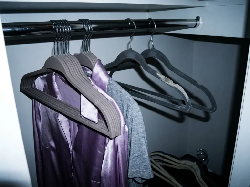Rubber non-slip hangers replacing worn velvet hangers deep in a dim closet