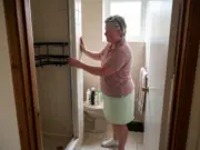 Shower Organization for Small Bathrooms That Fits Woman setting up shower organization for small bathrooms with a corner caddy in a narrow tiled stall