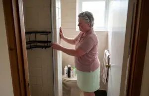 Shower Organization for Small Bathrooms That Fits Woman setting up shower organization for small bathrooms with a corner caddy in a narrow tiled stall