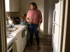 Why Your Small Kitchen With Few Drawers Stays Cluttered Woman standing in a small rental kitchen with only two drawers and utensils stacked on the counter
