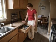 Spice Drawer vs Spice Rack? Your Tape Measure Decides Spice drawer open below a countertop spice rack in a kitchen, both storage options side by side