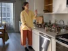 Spice Organization That Keeps Spices Fresh and Findable Woman sorting spice jars on a kitchen counter mid spice organization reset in a rental apartment