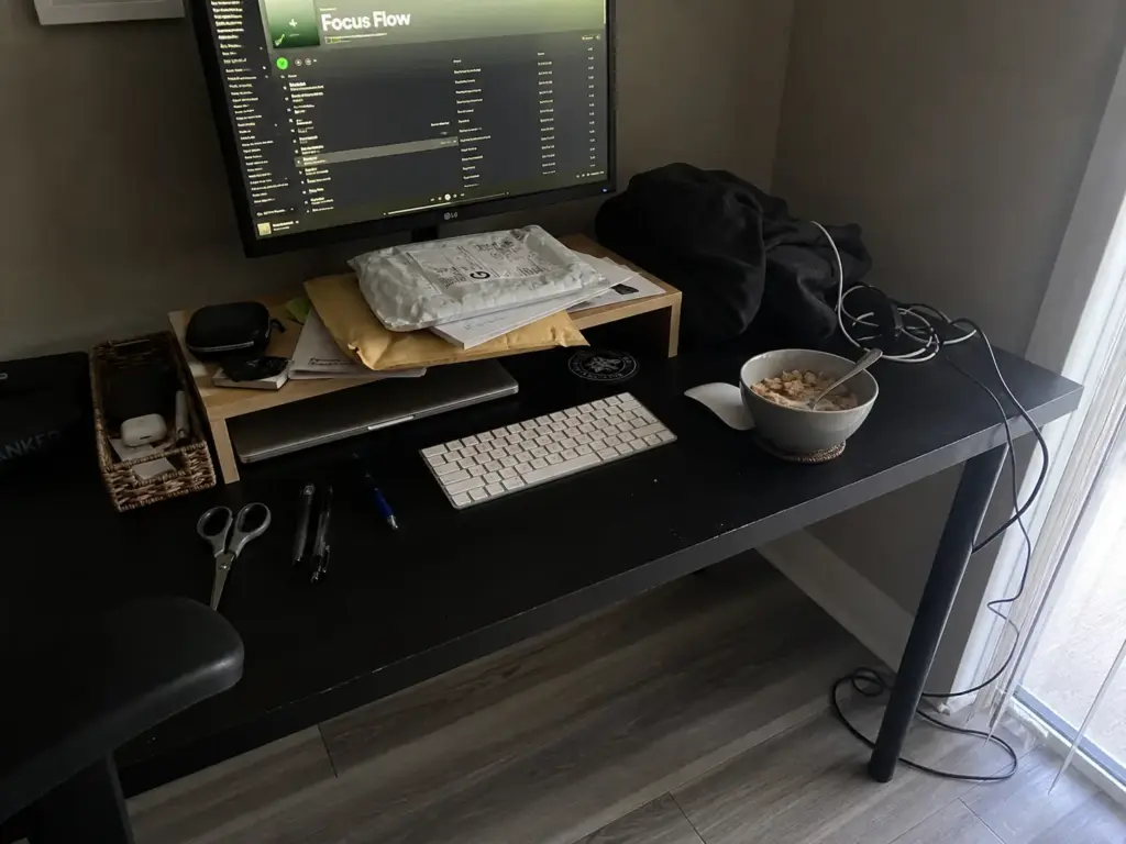 Aesthetic Desk Organization Ideas That Survive Week Two 1 Desk clutter creeping back onto a styled workspace with mail stacked on a tray and tangled cables