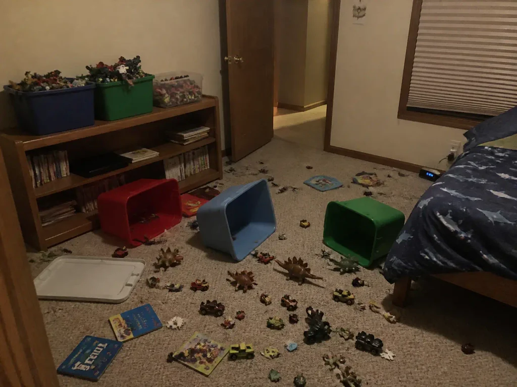 Toy bins emptied onto a kids bedroom floor showing why bin systems fail after a few weeks