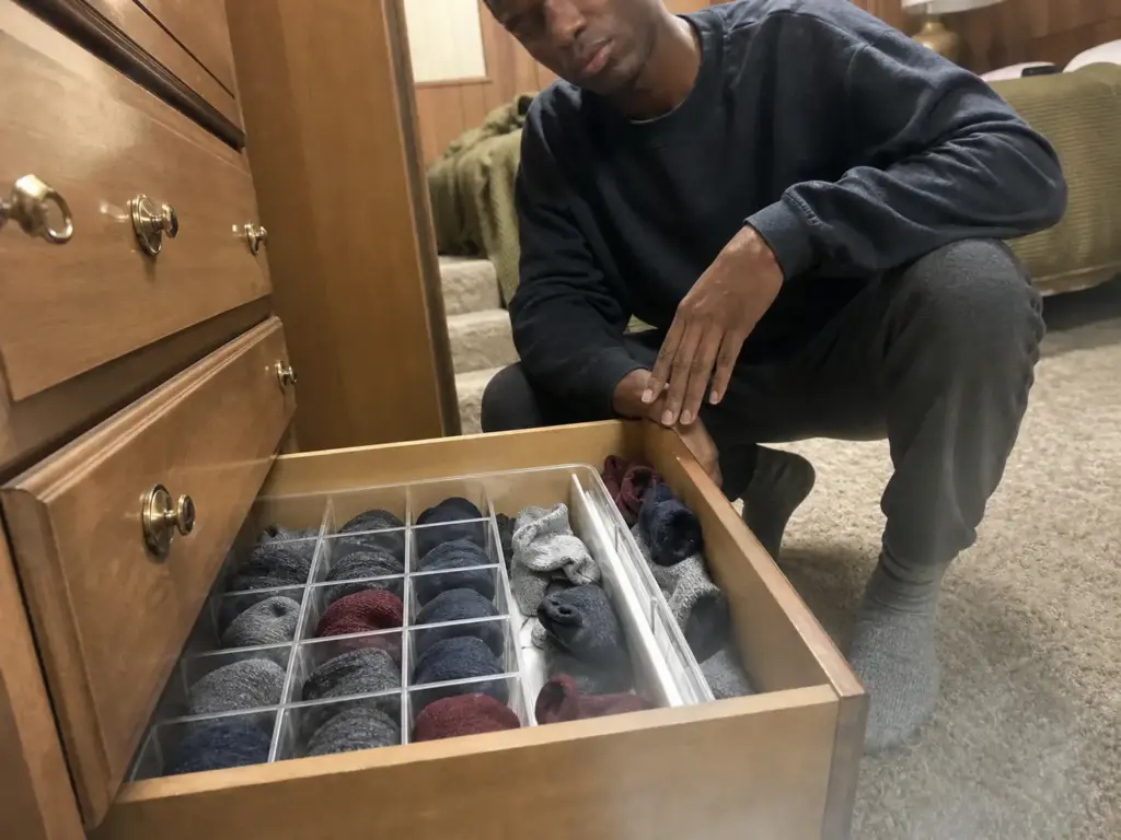 Best Drawer Dividers for Dressers That Actually Fit 4 Open dresser drawer with a compartment sock organizer beside a shifted expandable divider