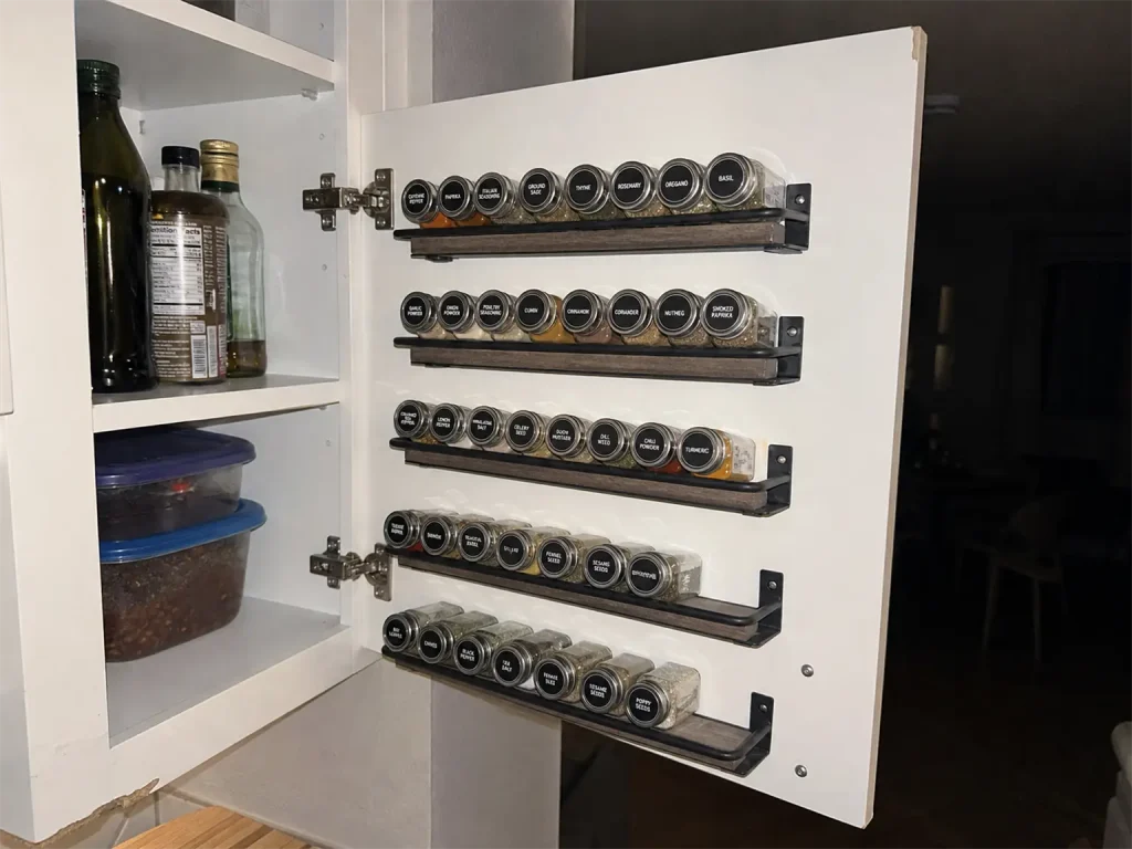 Best Spice Rack Organizers That Actually Stay Put 4 Spice rack organizer mounted inside a cabinet door, photographed with a direct flash