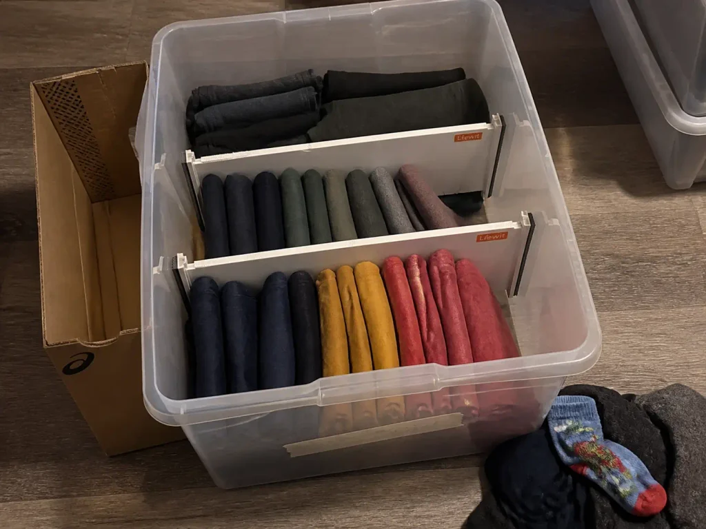 Overhead view of a kids clothes bin divided into type sections with adjustable drawer dividers