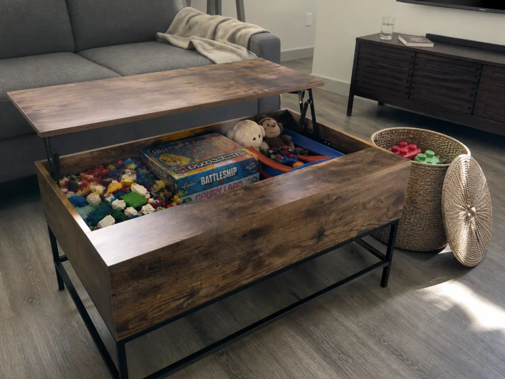 Lift top coffee table open showing hidden toy storage inside a small living room that looks toy free