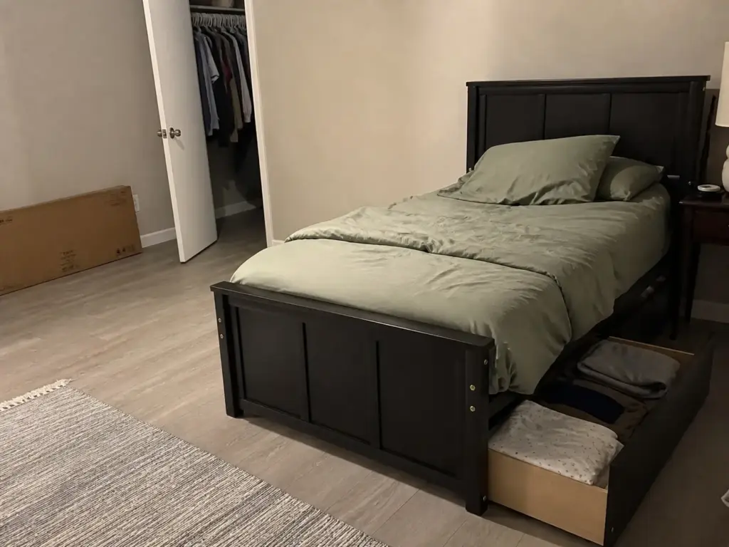 Twin platform bed with storage drawers in a small bedroom leaving open floor space