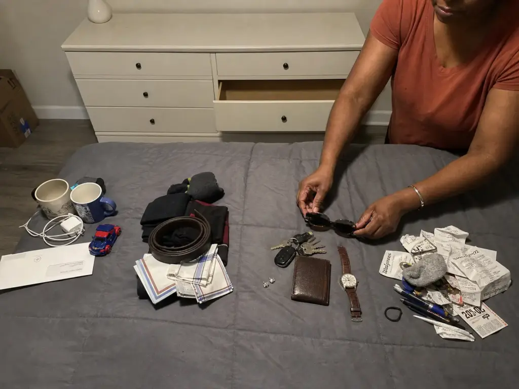 Dresser top sorted into four separate piles during a decluttering session in a rental bedroom