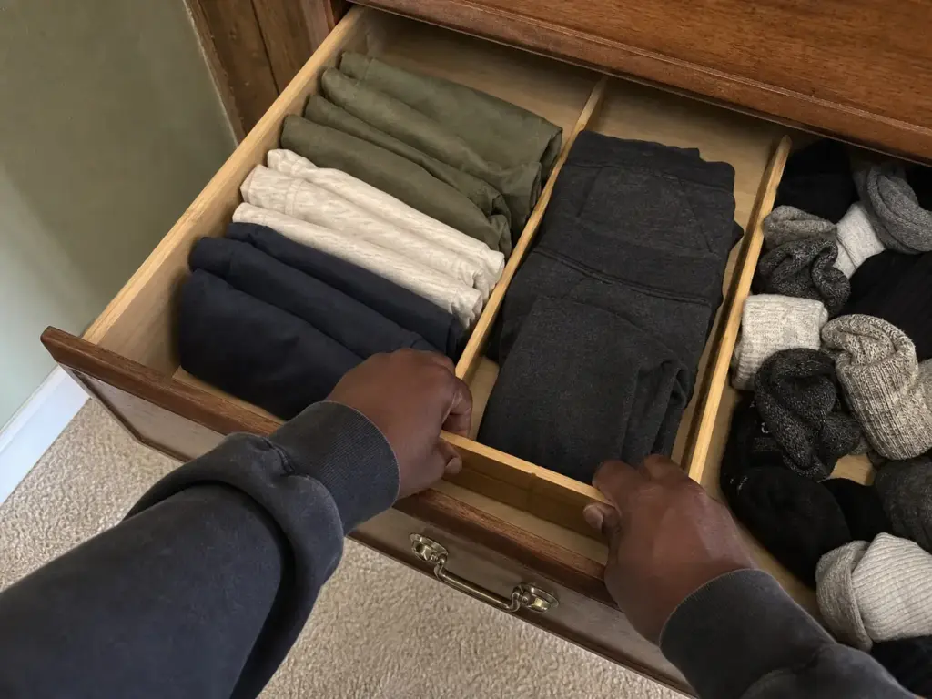 Best Drawer Dividers for Dressers That Actually Fit 6 Dresser drawer divided into three zones of folded clothes by two bamboo dividers