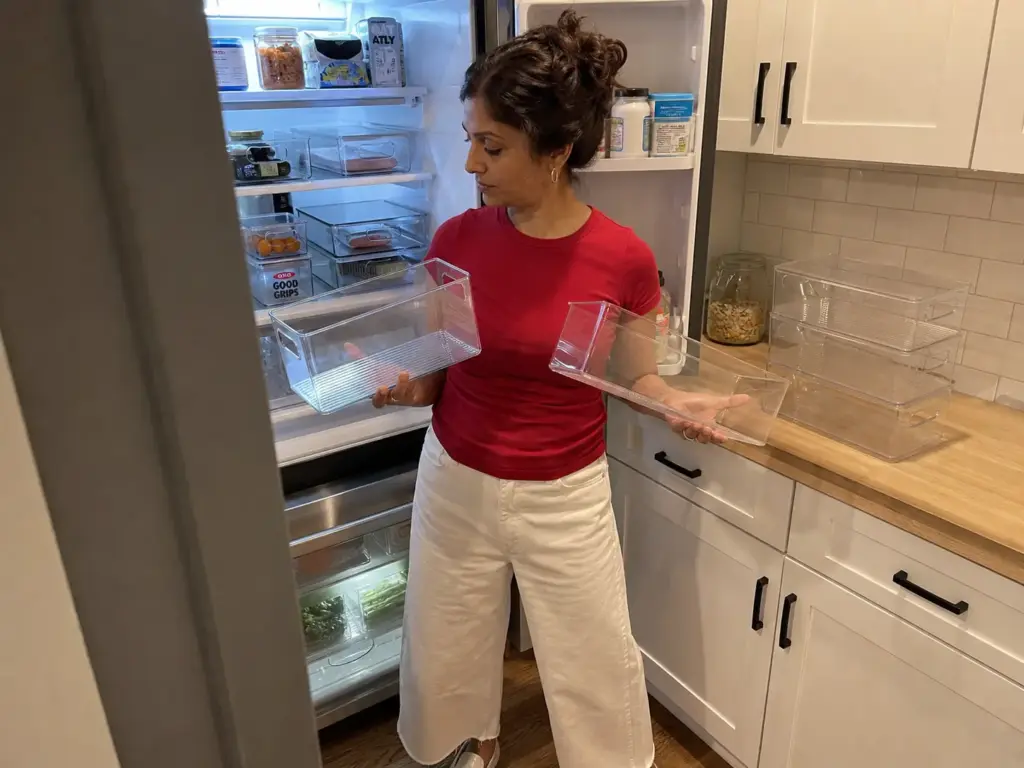 Two clear bins compared on a counter, one thick plastic, one acrylic split at the handle