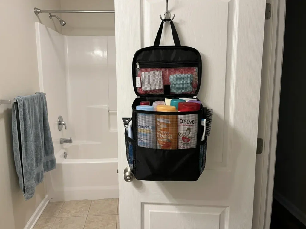 Best Shower Caddies for Renters and Shared Baths 9 Portable mesh shower caddy tote packed and hanging on a door hook in a shared bathroom