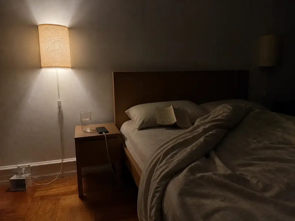 How to Make a Small Bedroom Look Bigger for Renters 5 Plug-in wall sconces lighting a small bedroom at wall height beside the bed with no hardwiring