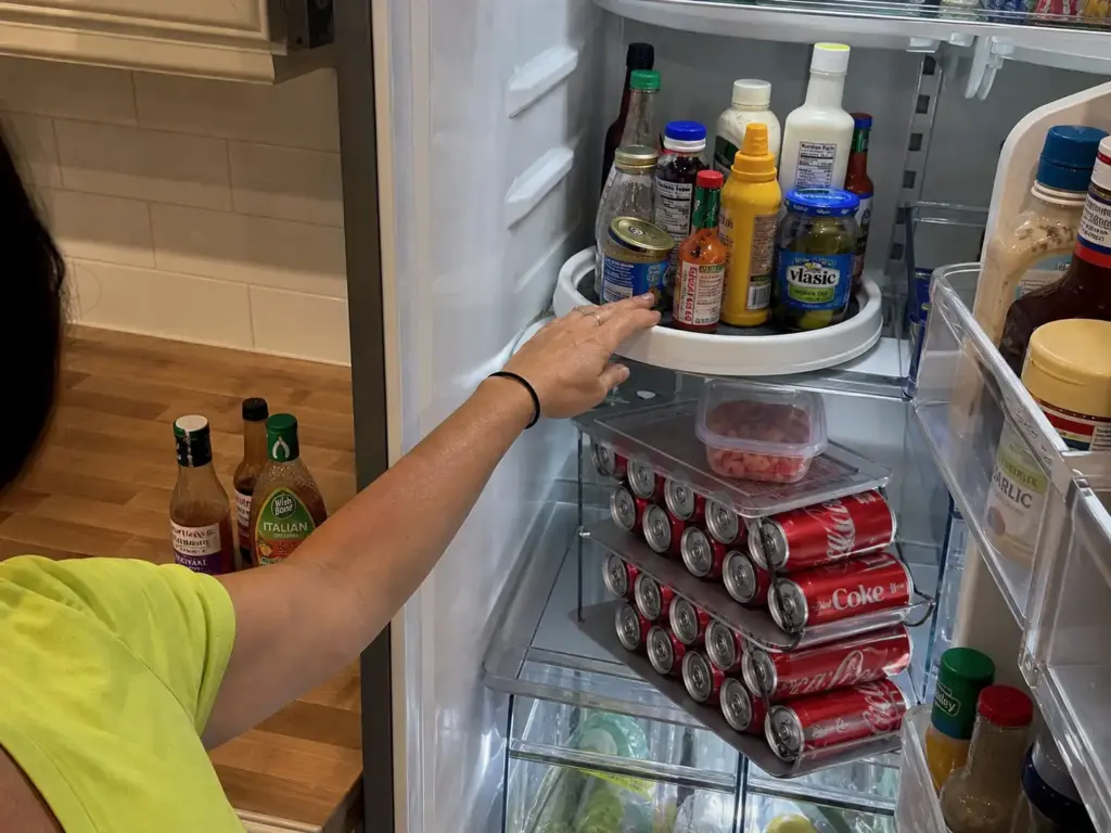 LALASTAR pull-out drawer fridge bin extended on a deep refrigerator shelf at night