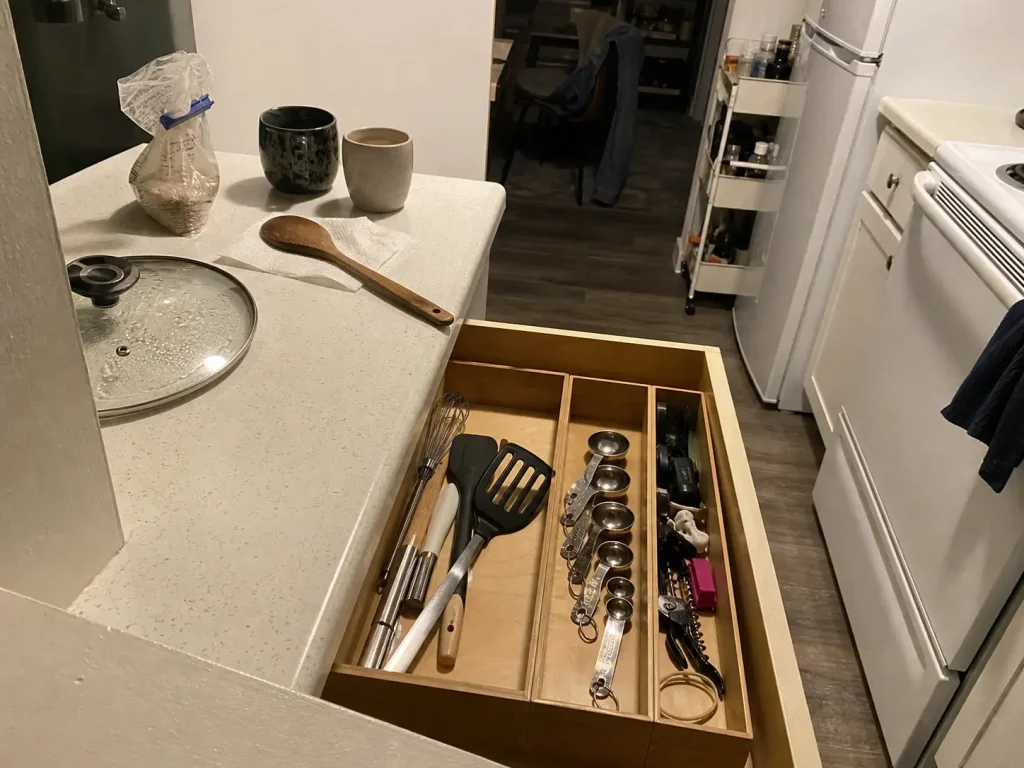 Why Your Small Kitchen With Few Drawers Stays Cluttered 7 Open kitchen drawer with bounded zones still holding after weeks of use in a shared small kitchen
