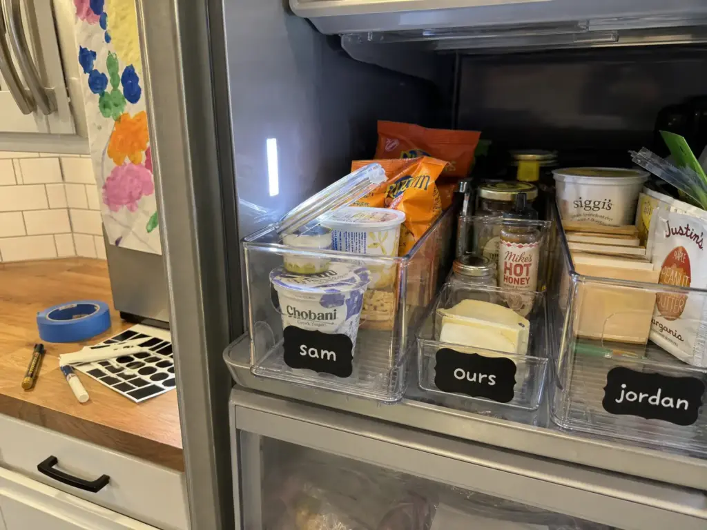 Woman loading greens into SILIVO produce containers in a crisper drawer with eggs above