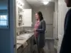 Best Medicine Cabinet Organizer Inserts for 3-Inch Shelves Woman fitting a shallow acrylic organizer tray into a rental medicine cabinet above the bathroom sink