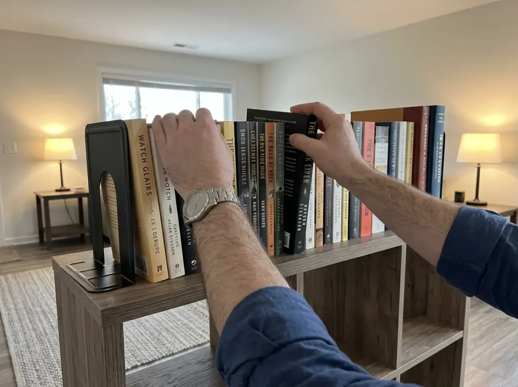 Out of Shelf Space? Organize Books in a Small Apartment 4 Metal bookends holding paperbacks upright on top of a cube storage unit