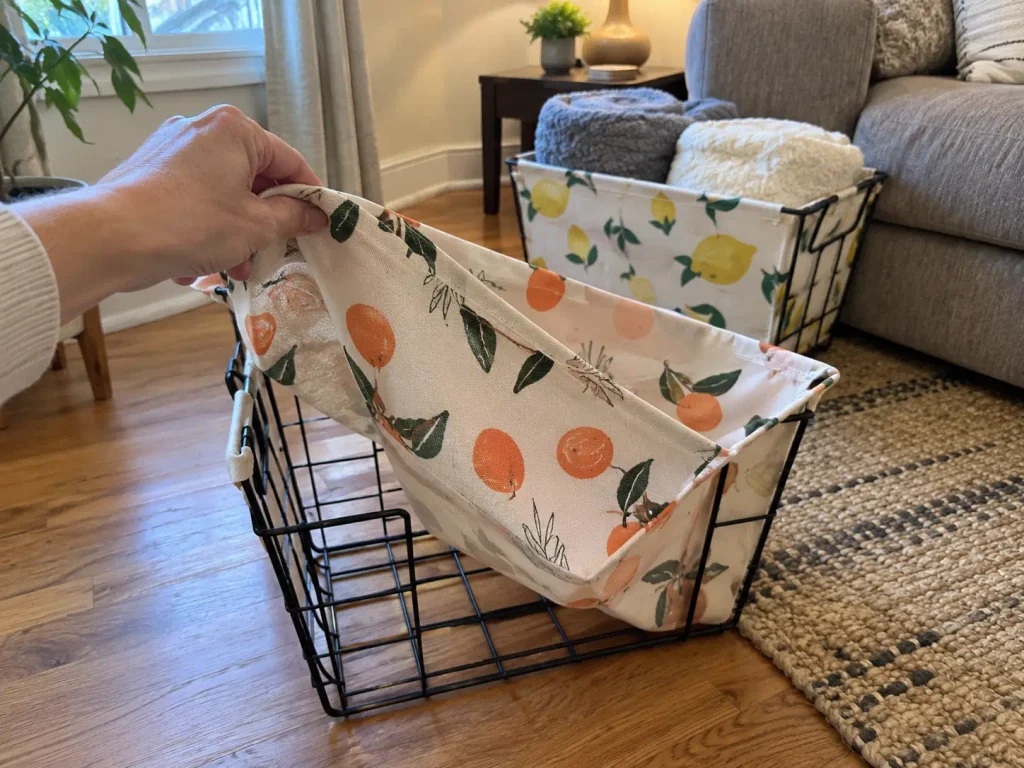 Wire storage basket with its fabric liner pulled out on a bungalow living room floor for washing