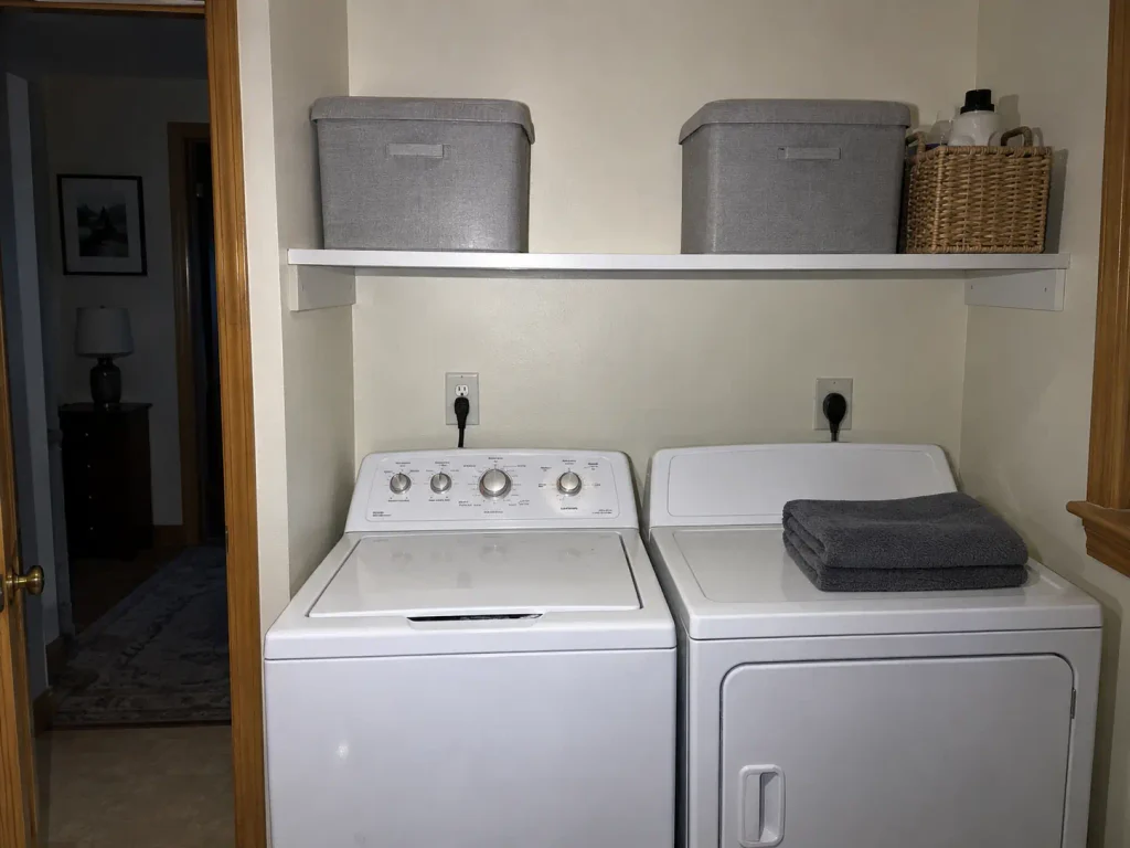 Organized laundry room shelf with labeled bins and a basket, three months into daily use